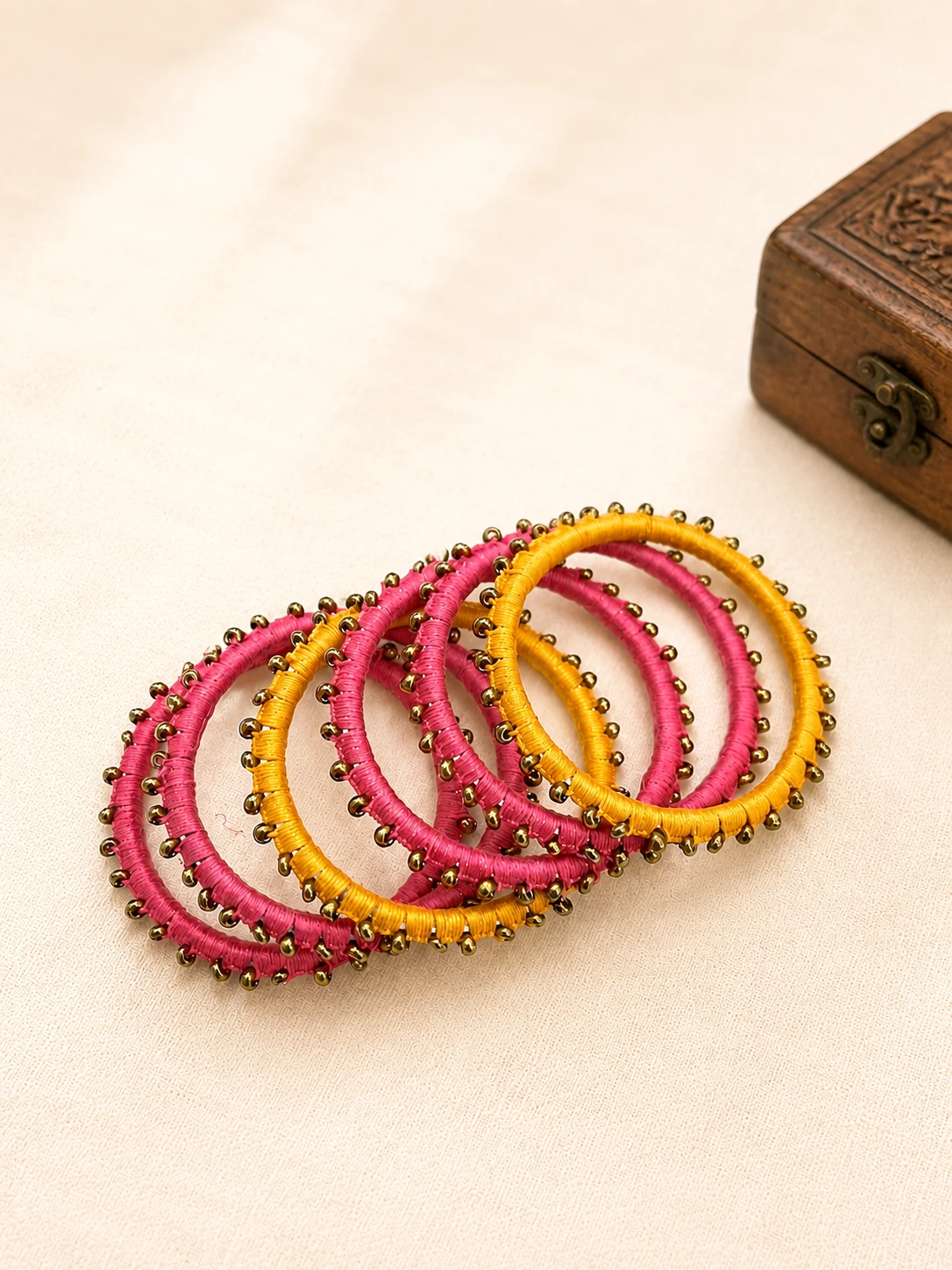 Handmade pink and mustard yellow beadwork thread bangles set of 6 with golden bead embellishments