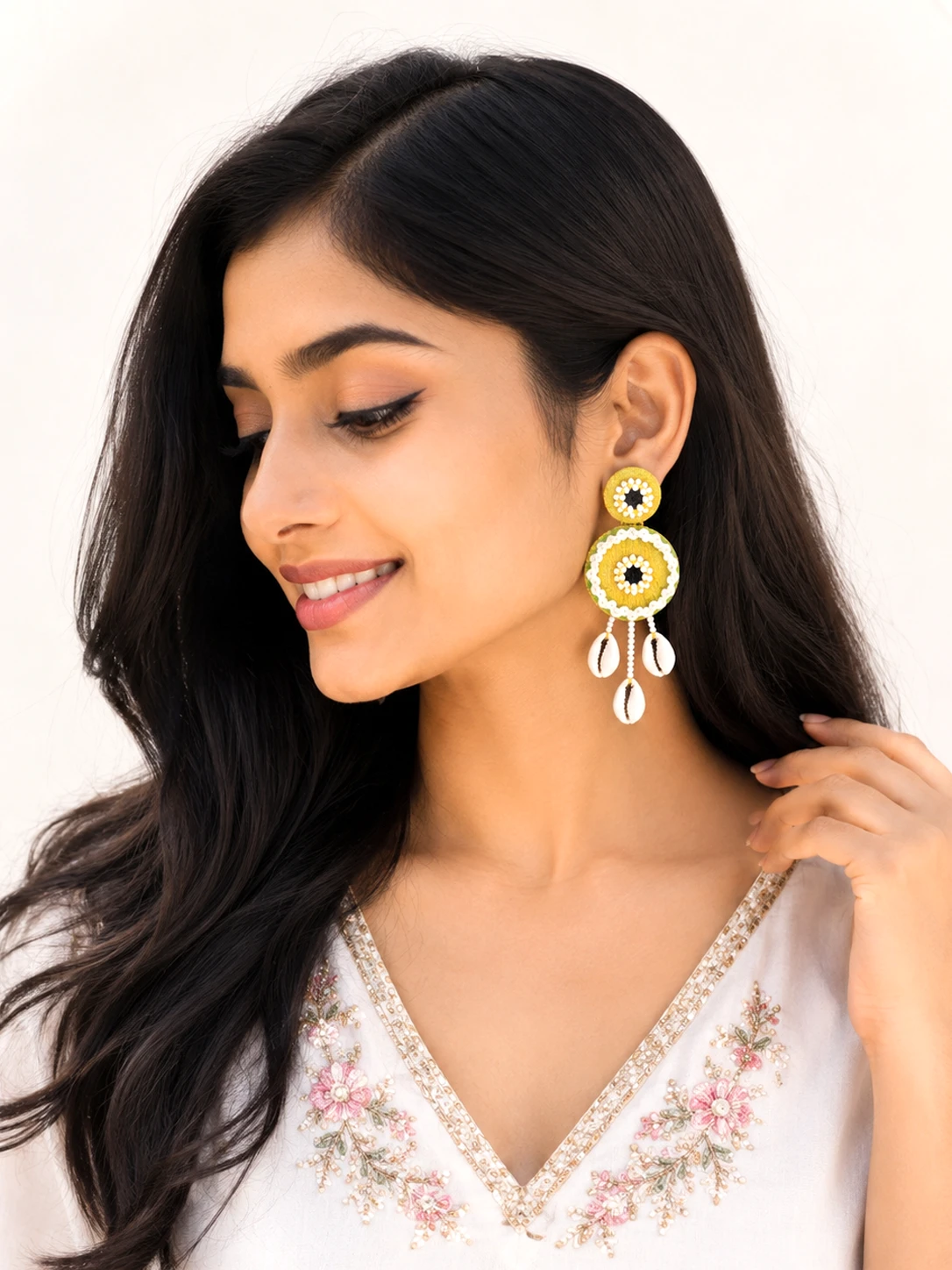 Handmade olive green mirror shell earrings with braided thread border and cowrie shell drops