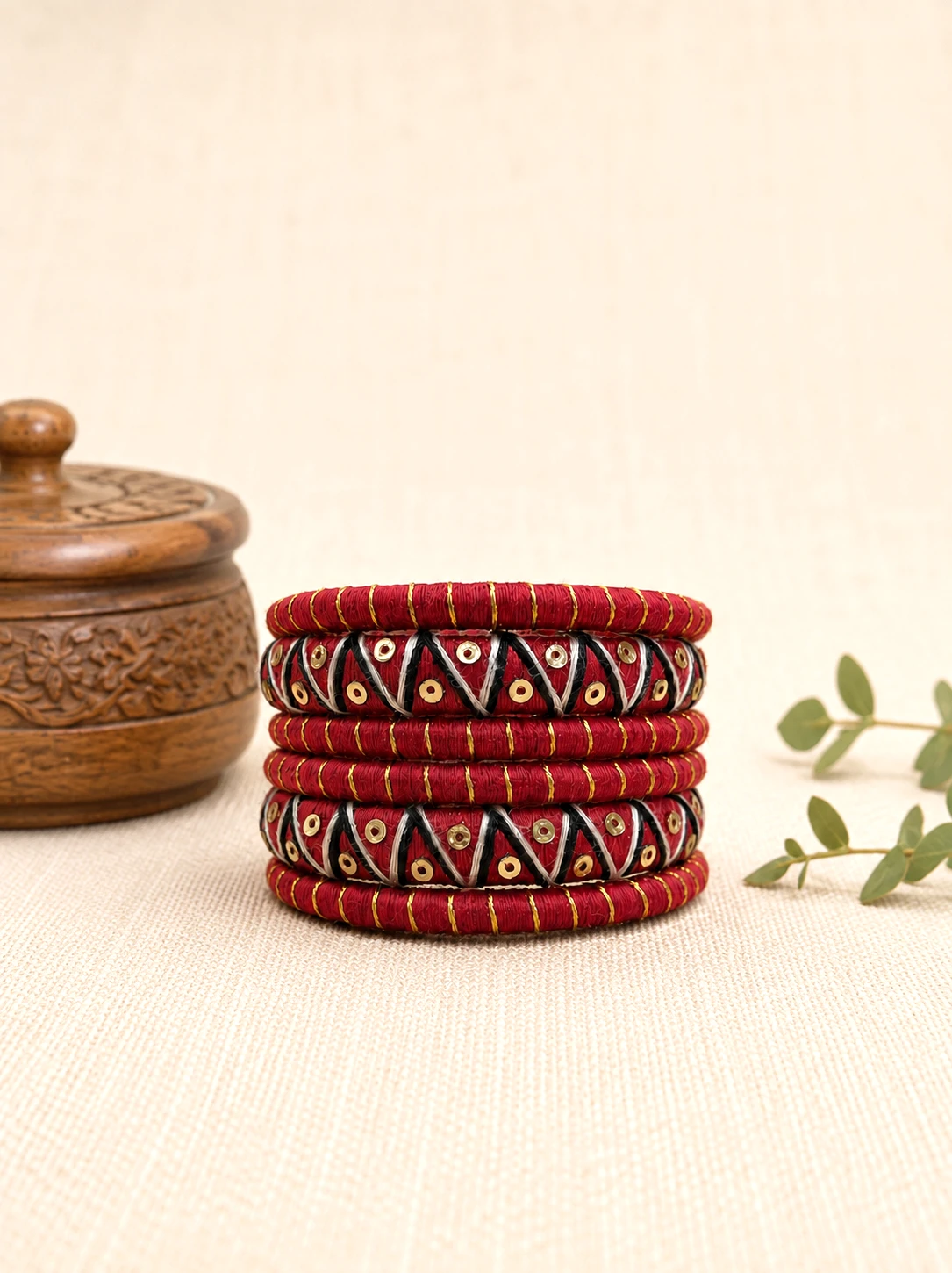 Red black and gold handmade thread bangles with traditional geometric detailing