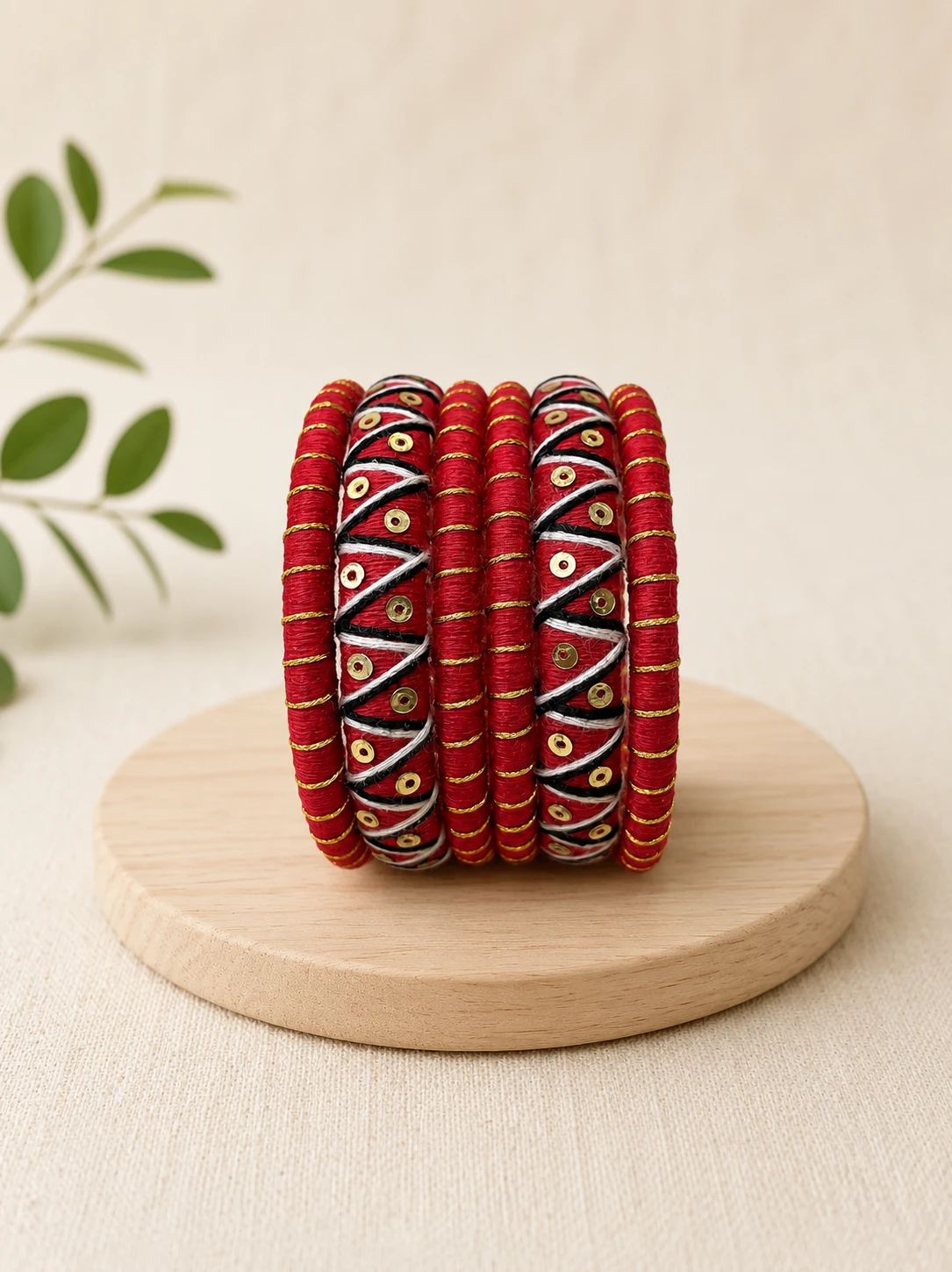 Red black and gold handmade thread bangles with traditional geometric detailing