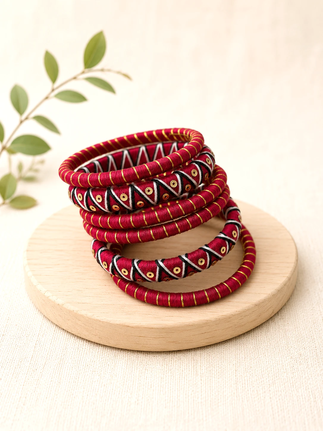 Red black and gold handmade thread bangles with traditional geometric detailing